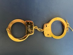 Smith and Wesson LEHMAN BROS. gold plated M100 handcuff.