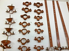 Lot Of Copper Epoxy Coated Pipe Hanger parts. (These are not made of copper)